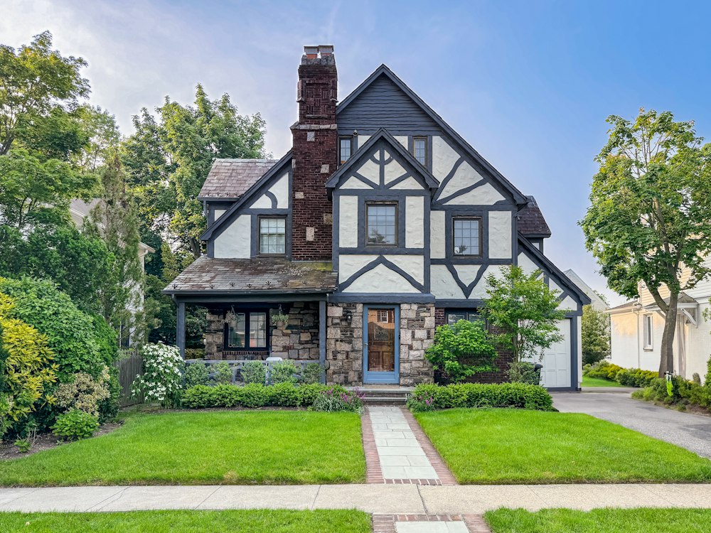 Tudor-style home with a landscaped yard